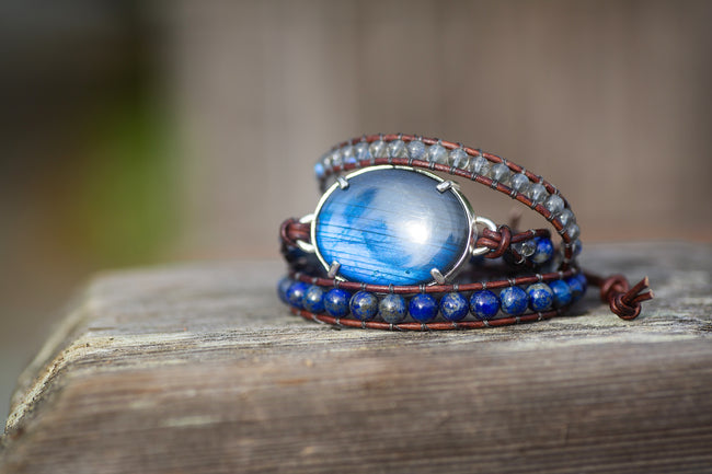 A triple wrap adjustable bracelet that features a large blue labradorite gemstone in sterling silver. 