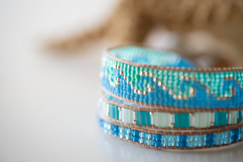 A wave patterned beaded triple wrap adjustable bracelet with a surfer coastal vibe. 