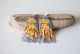 Octopus themed beaded fringe earrings in tan, blue, green, and brown. 