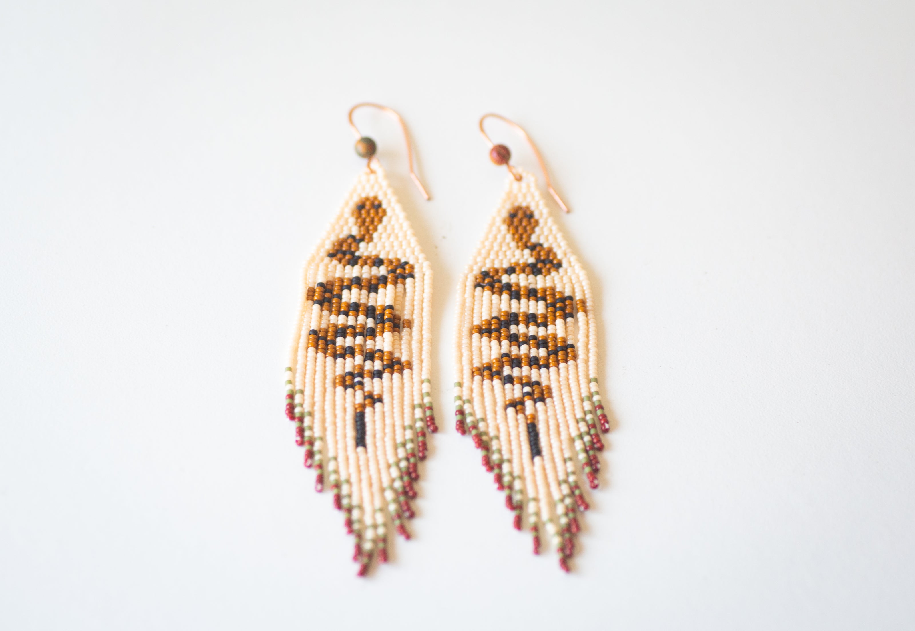 Beaded snake themed fringe earrings, handmade with copper ear hooks.