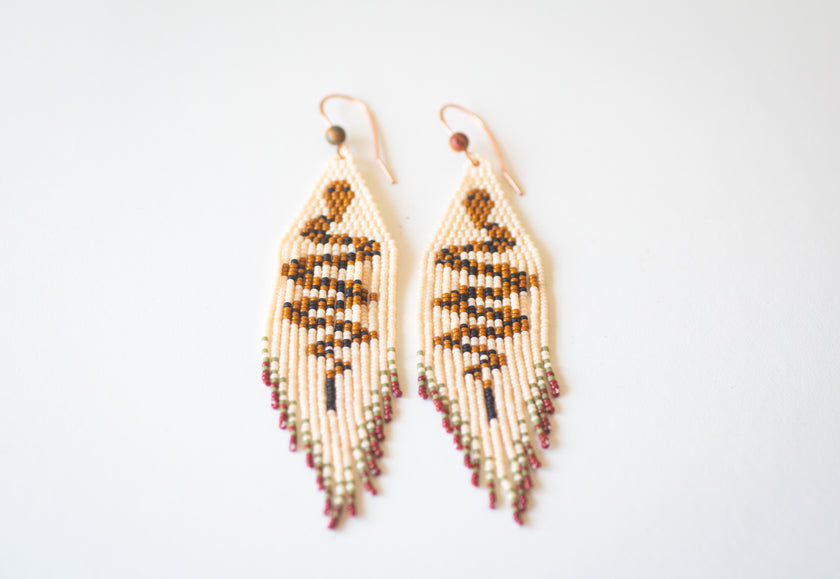 Beaded snake themed fringe earrings, handmade with copper ear hooks.