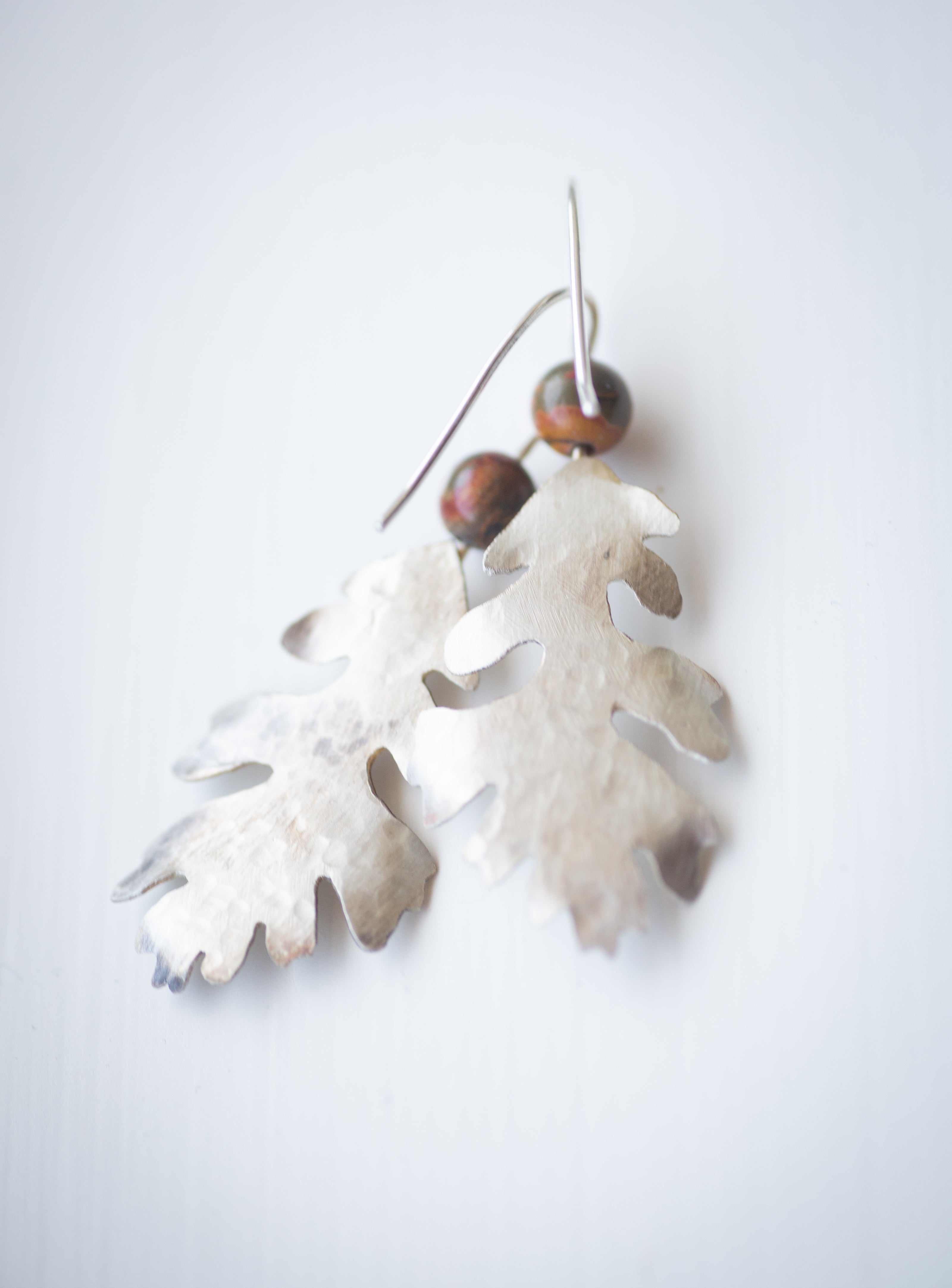 hammered sterling silver valley oak tree earrings with a jasper bead. 
