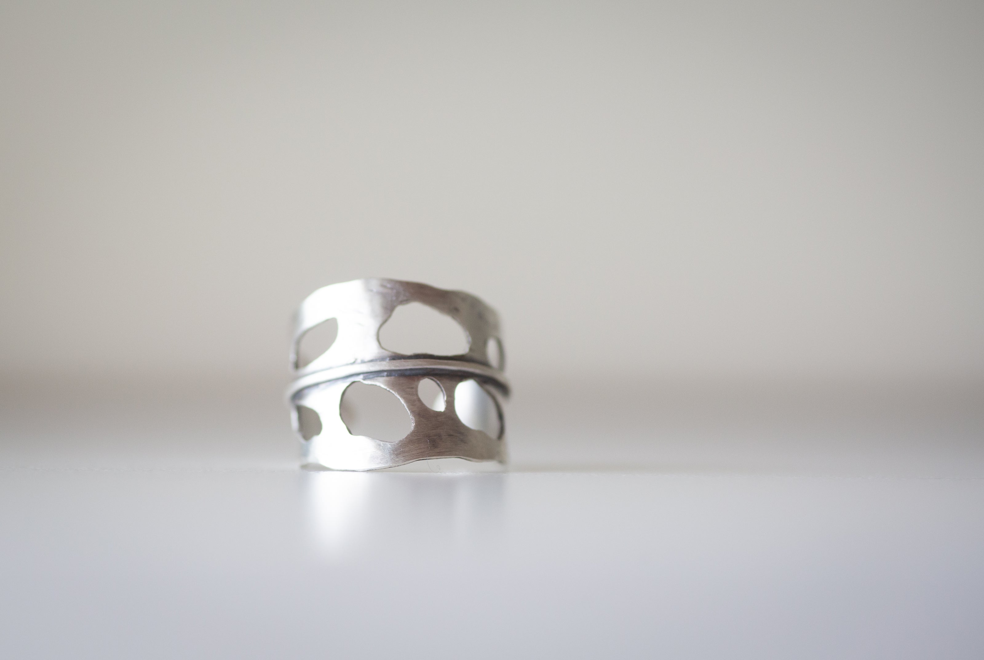 Silver ring with cut-out design made to look like a Monstera Leaf. 