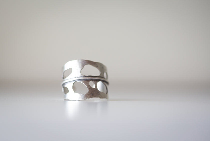 Silver ring with cut-out design made to look like a Monstera Leaf. 