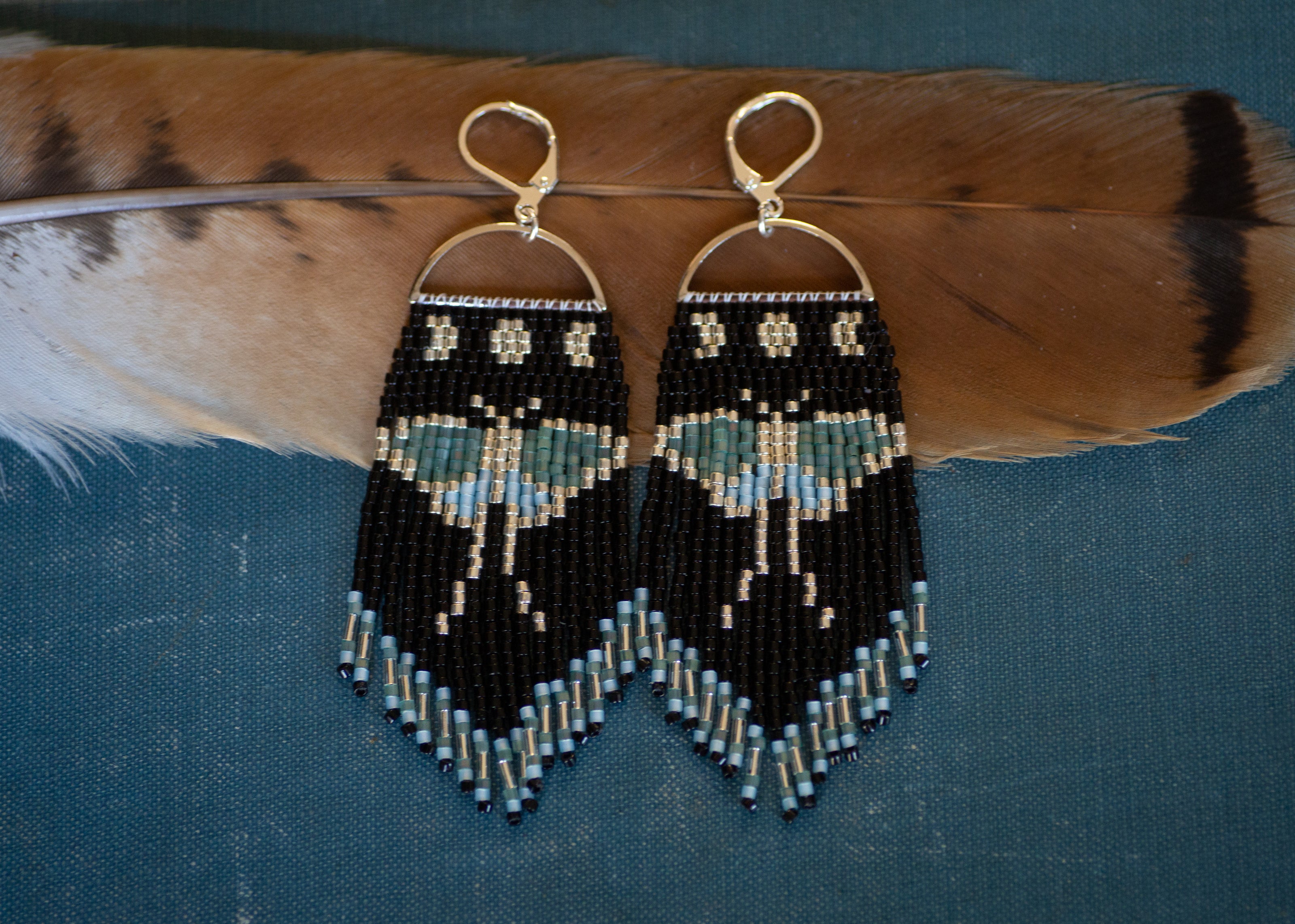 Luna moth beaded fringe earrings in silver, black, green, and blue with sterling silver plated ear hooks. 