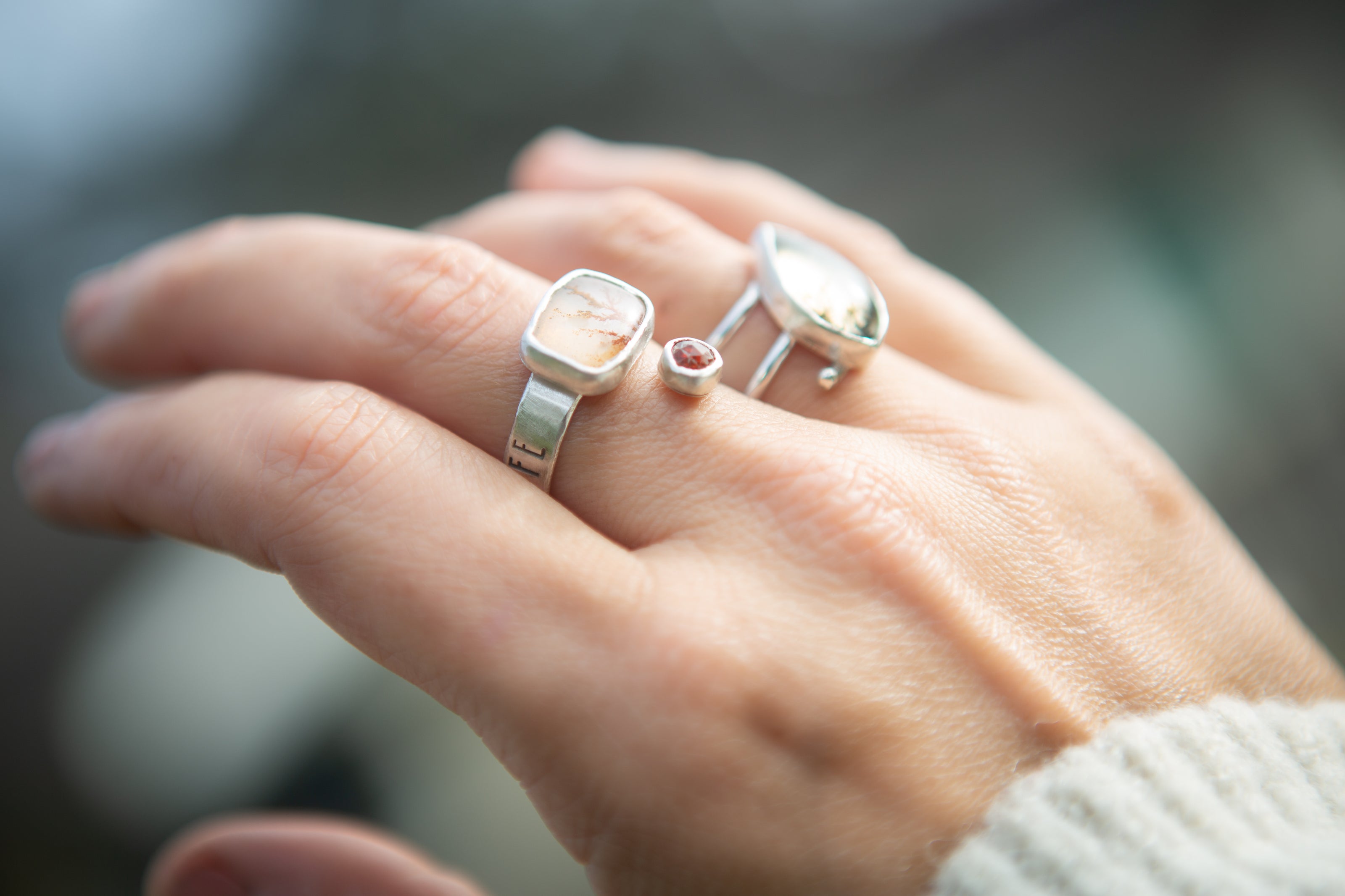 A sterling silver and dendritic agate ring paired with a tiny citrine stone. 