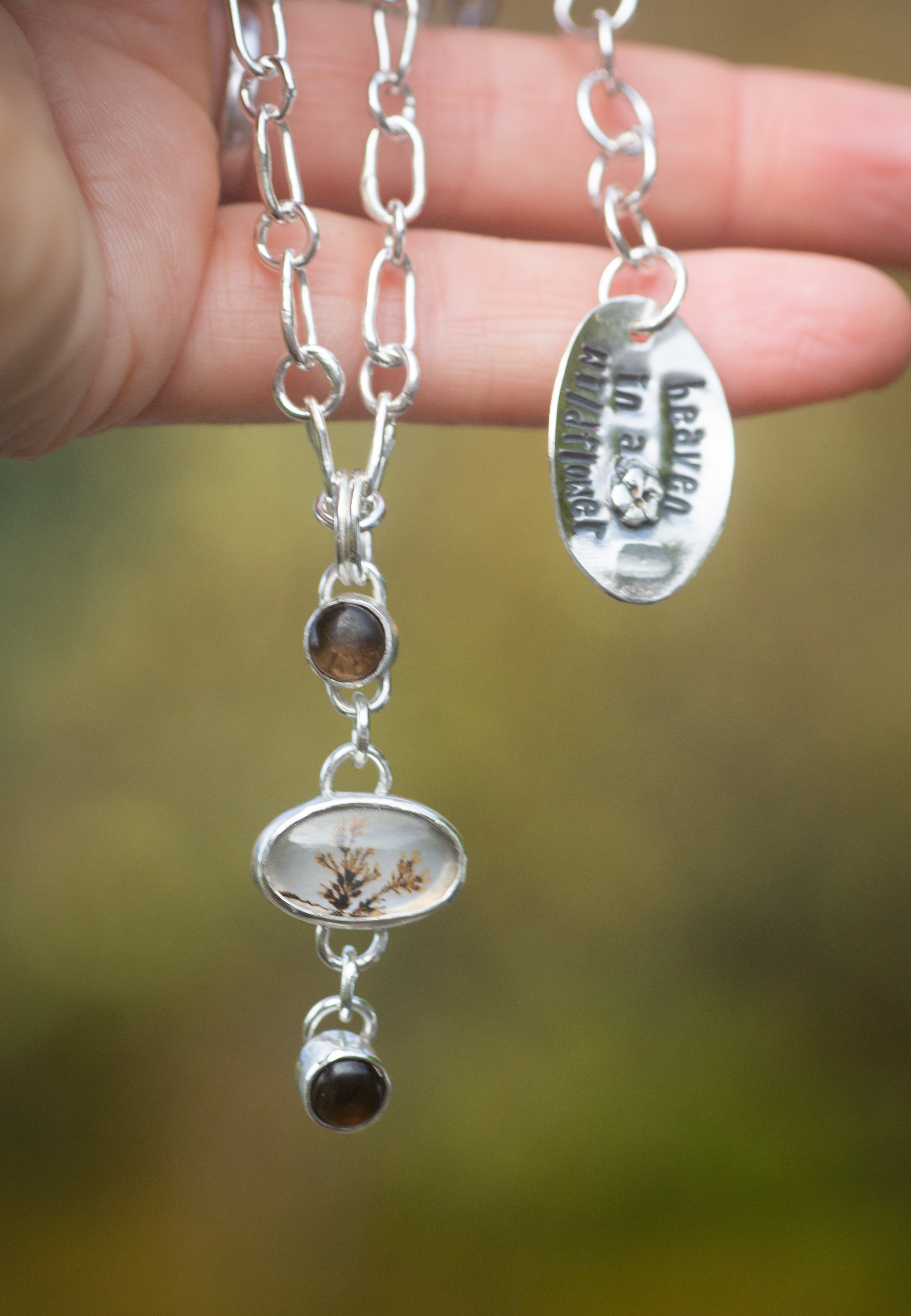 Sterling Silver handmade necklace with a natural dendritic agate and two 5mm smokey quartz pieces, attached to form a pendant. The tag reads 