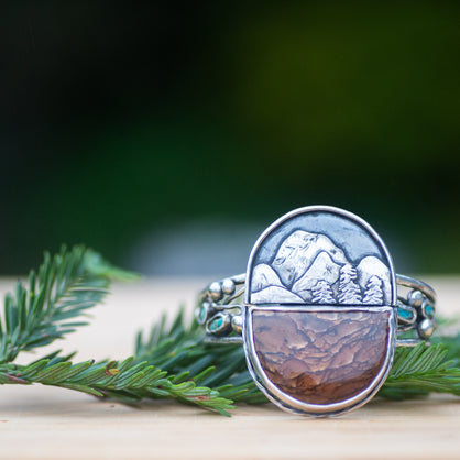 Large handmade unique sterling silver cuff with a mountain scene. Includes a half circle shaped Deschutes picture jasper from Oregon and Kingman turquoise. 