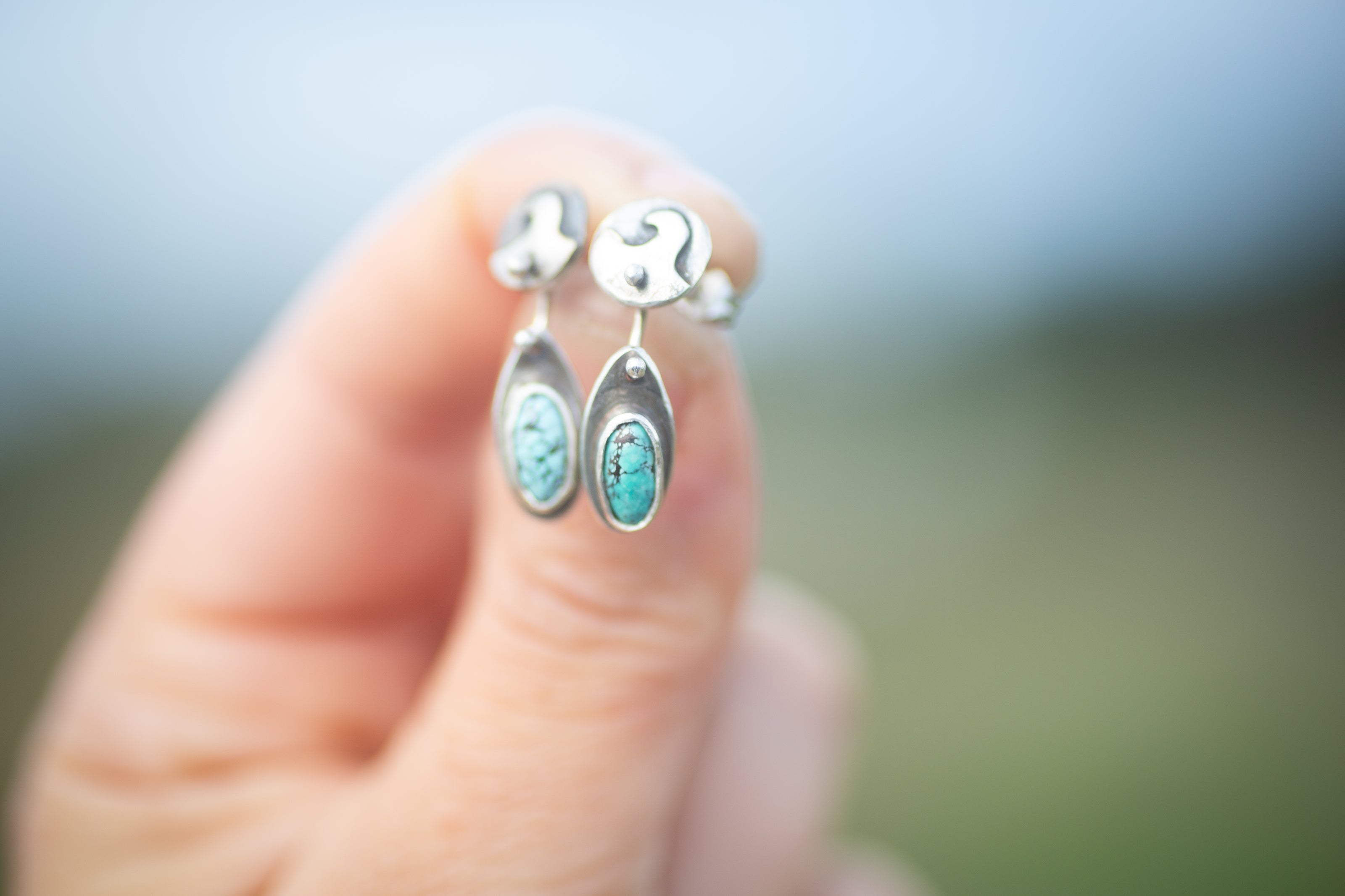 The surf inspired beach earrings are handmade from sterling silver and also have natural kingman turquoise oval stones. The surfboards move independently from the wave studs. They even have tiny fins on the backs. 