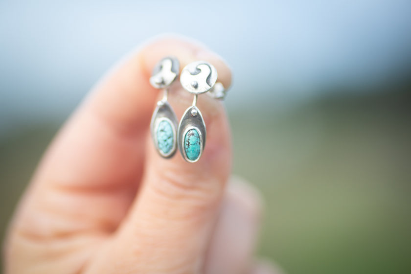 The surf inspired beach earrings are handmade from sterling silver and also have natural kingman turquoise oval stones. The surfboards move independently from the wave studs. They even have tiny fins on the backs. 