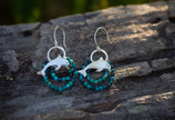 Dolphin earrings in sterling silver with beaded turquoise colored gemstones. 