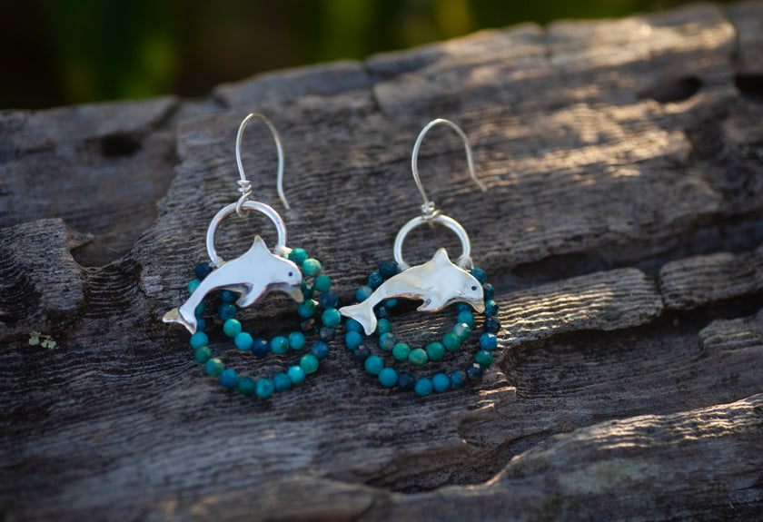 Dolphin earrings in sterling silver with beaded turquoise colored gemstones. 