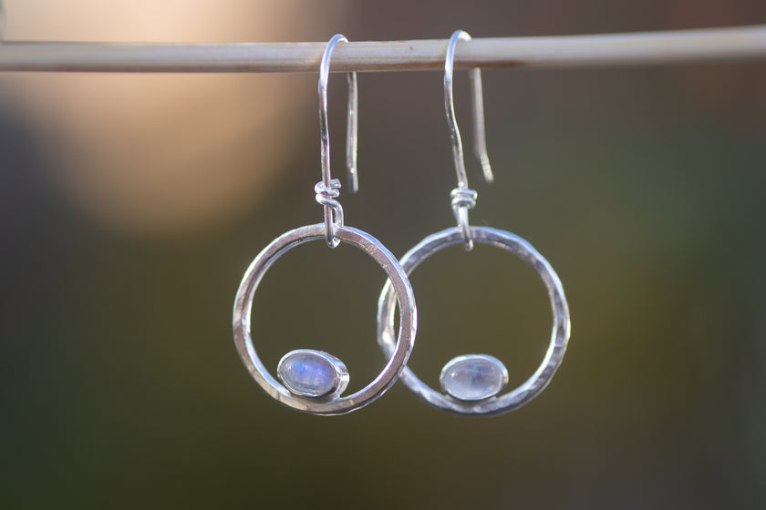 Earring hoops in sterling silver with tiny moonstone ovals. 