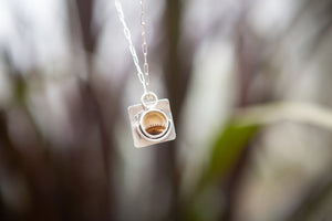 Silver dendritic agate pendant necklace with the words Splendour in the Grass from the poem by William Wordsworth. 