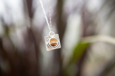 Silver dendritic agate pendant necklace with the words Splendour in the Grass from the poem by William Wordsworth. 